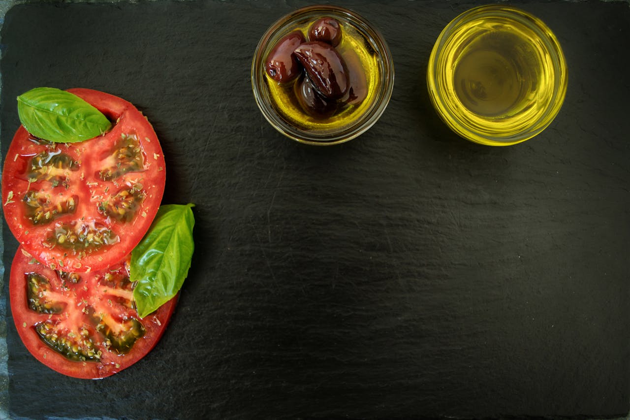 Tomates cerises et feuilles de basilic frais sur une planche